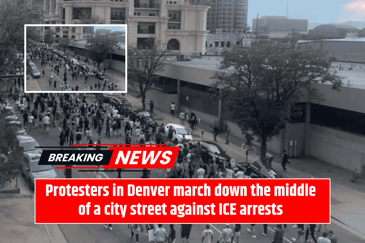 Protesters in Denver march down the middle of a city street against ICE arrests